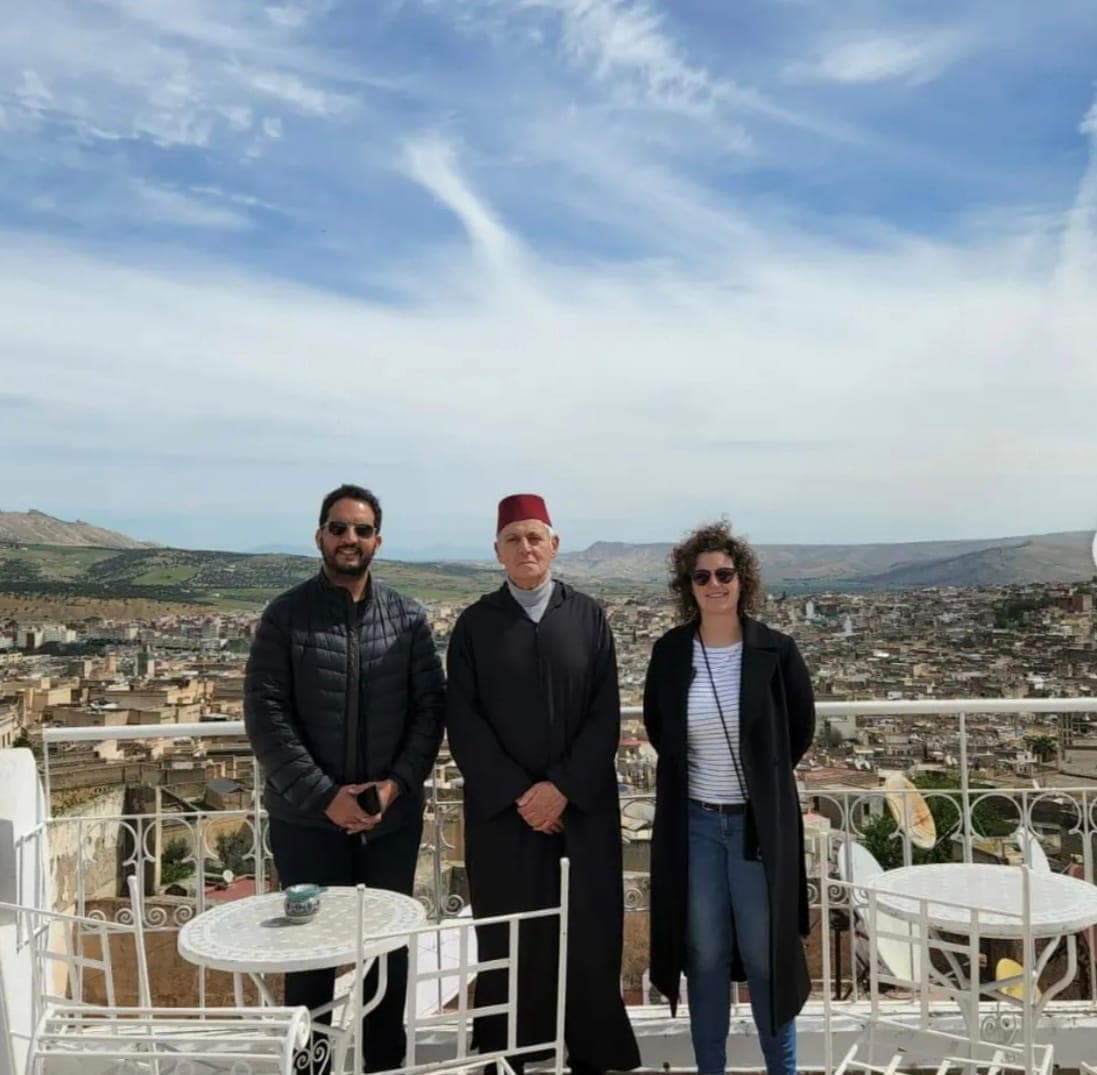 The guide with visitors on a riad rooftop above the Fes medina